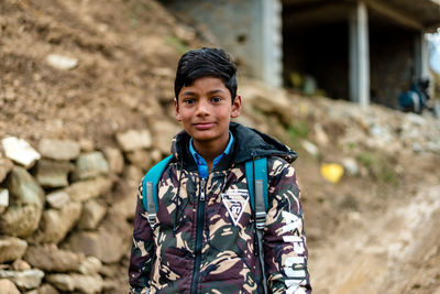 Portrait of boy standing outdoors