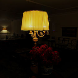 Close-up of illuminated lamp on table at home