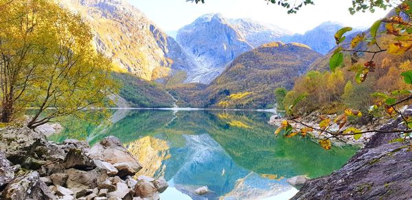 Scenic view of lake by mountains during autumn