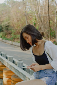 Young woman looking at smartphones and texting 