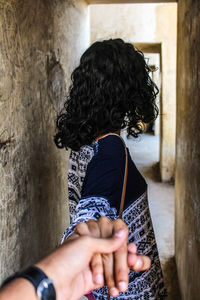 Cropped image of man holding woman hand in fort