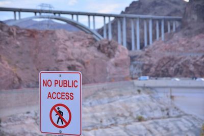 Close-up of warning sign on bridge