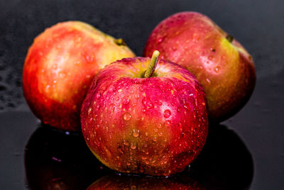 Close-up of wet apple on table