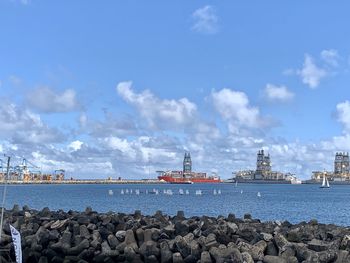 Commercial dock by sea against sky