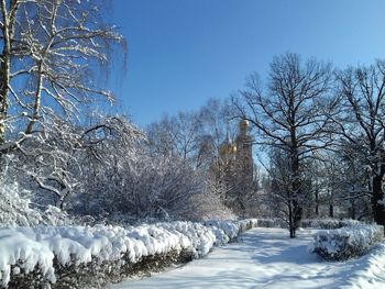 Snow covered landscape against clear sky