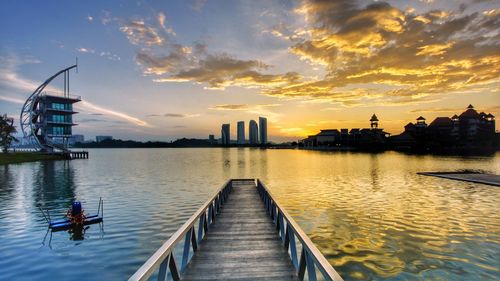 View of city at waterfront during sunset