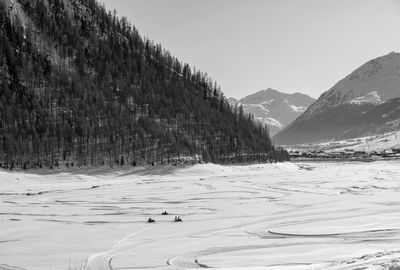 Scenic view of snow covered mountains against sky