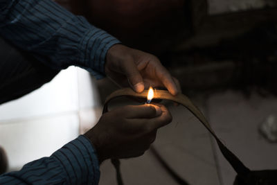 Close-up of hand holding burning