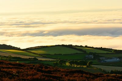 Scenic view of landscape against cloudscape during sunset