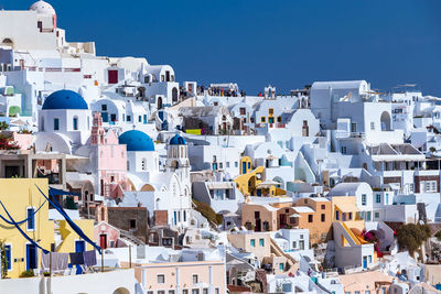 Buildings in city against blue sky