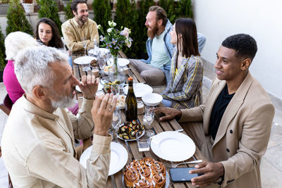 Friends toasting drinks on table