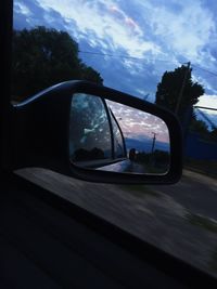 Reflection of car on side-view mirror