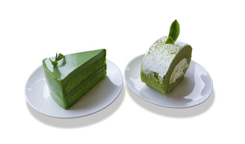 Close-up of cake on plate against white background