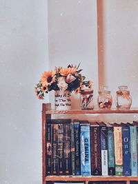 Close-up of potted plant in vase against wall