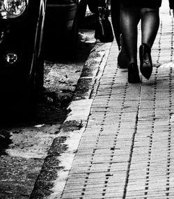 Low section of women standing on street