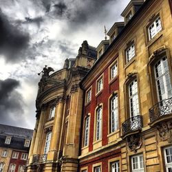 Low angle view of building against cloudy sky