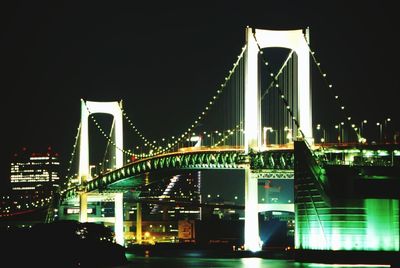 Illuminated bridge at night