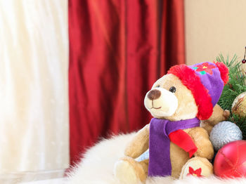 Teddy bear and christmas decorations at home