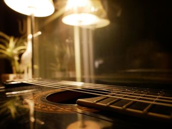 Close-up of guitar against lights