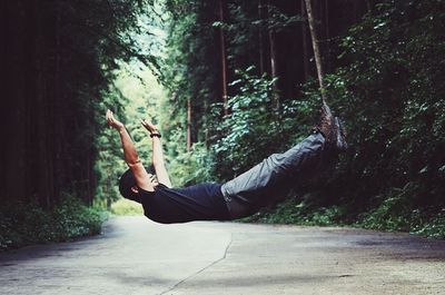 Man falling on forest road