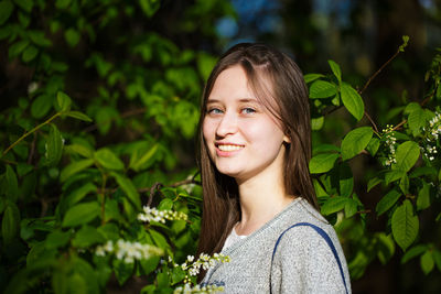 Portrait of a girl on a background of green foliage