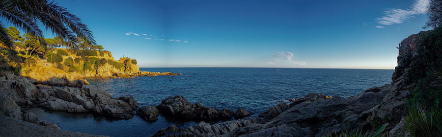 Scenic view of sea against blue sky