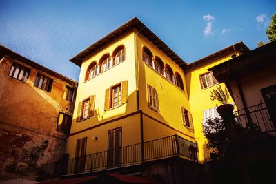 Low angle view of yellow building against sky