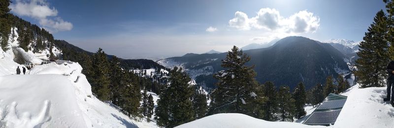 Scenic view of snow covered mountains against sky