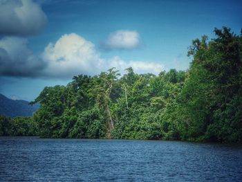 Scenic view of calm lake against cloudy sky