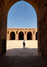 Rear view of man standing in tunnel