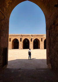 Man standing in tunnel of architecture place in the shadows