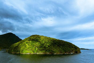 Scenic view of sea and mountains against sky