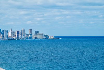 Sea and buildings against sky