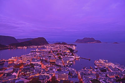 High angle view of townscape by sea against sky