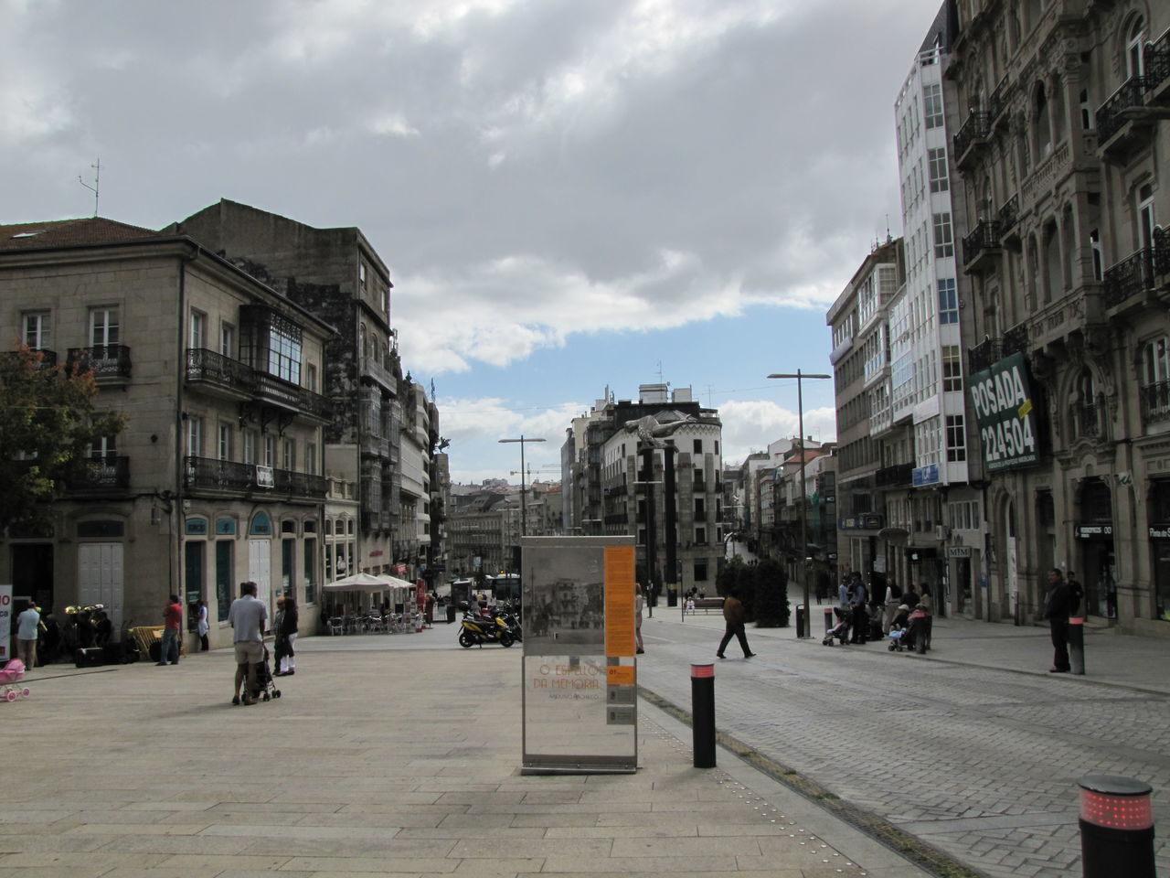 CITY STREET AMIDST BUILDINGS AGAINST SKY