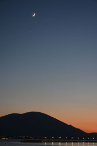 Scenic view of sea against clear sky at night