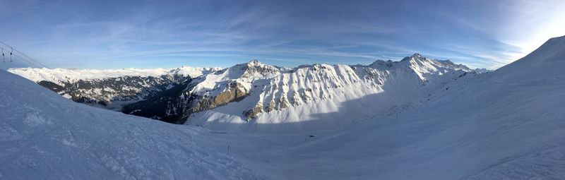 Scenic view of snow covered mountains against sky