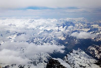 Aerial view of snowcapped mountains against sky