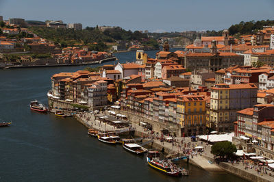 High angle view of townscape by sea against sky