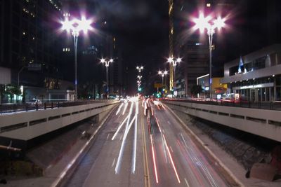 Light trails on road in city at night