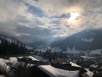 View of cityscape against cloudy sky during winter