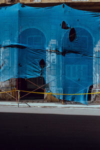 Building covered with tarpaulin