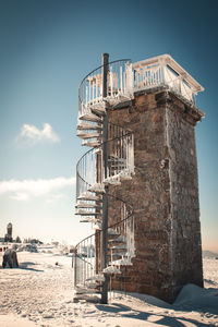 Built structure on beach against sky