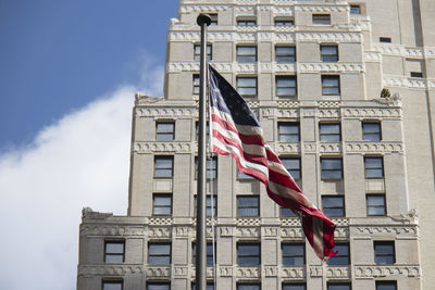 Low angle view of flag against building