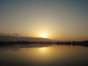 Scenic view of lake against sky during sunset