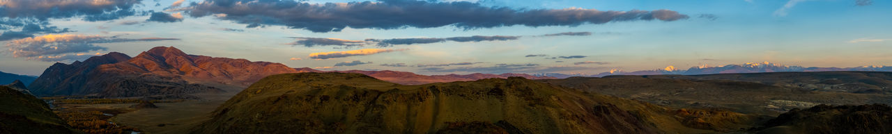 Panoramic view of mountains against cloudy sky