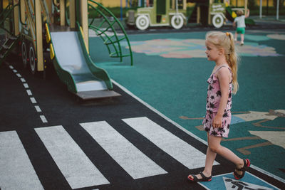 Little girl playing on the playground in the traffic rules