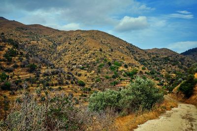 Scenic view of mountains against cloudy sky