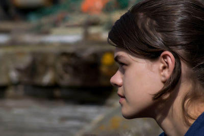 Side view of thoughtful young woman during sunny day