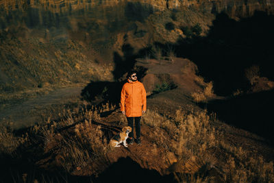 Rear view of man walking with his beagle dog